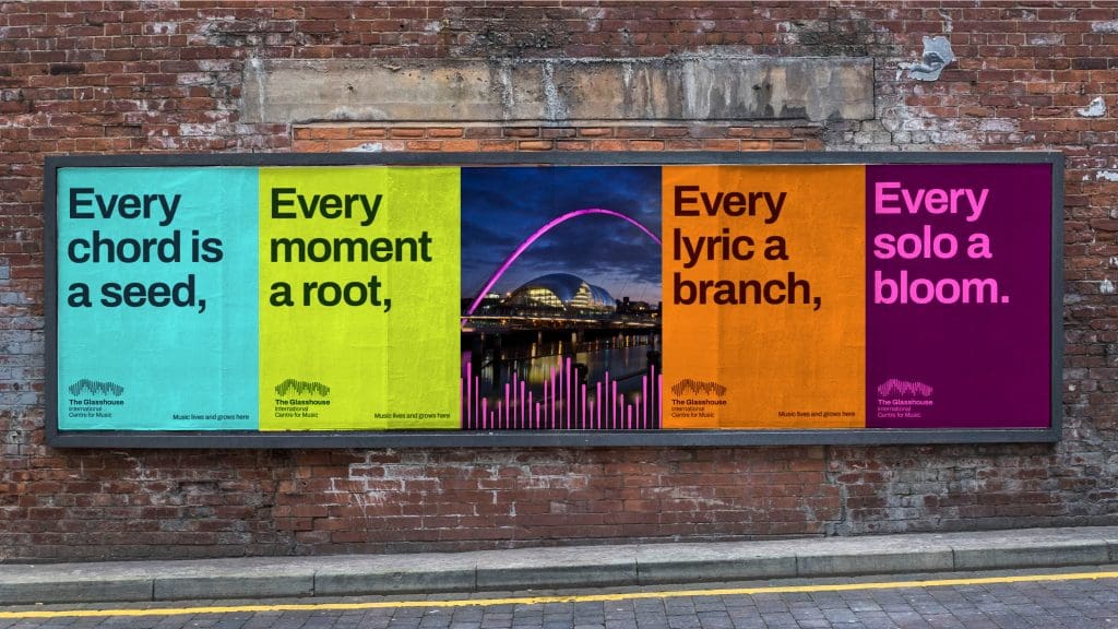Visual of 5 fly posters in a large frame on a brick wall in the street. There are 4 brightly coloured text-based posters and one central image. The posters read left to right, Every chord is a seed, Every moment is a root, the central poster is an image of the glasshouse building, then every lyric is a branch, and every solo a bloom. The image demonstrates the identity in an out-of-home advertisement.